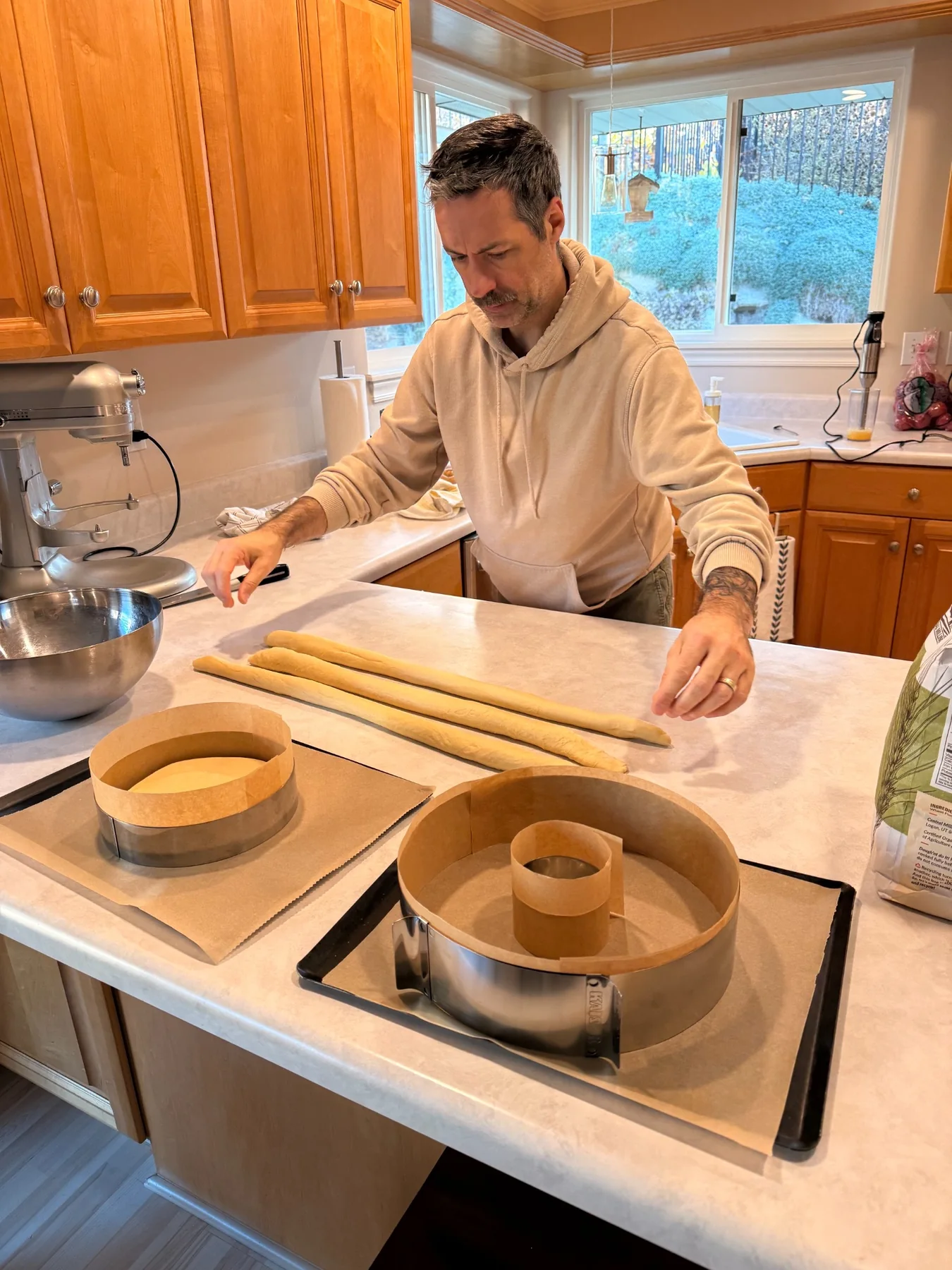 Jérôme preparing pastry rings on a kitchen counter