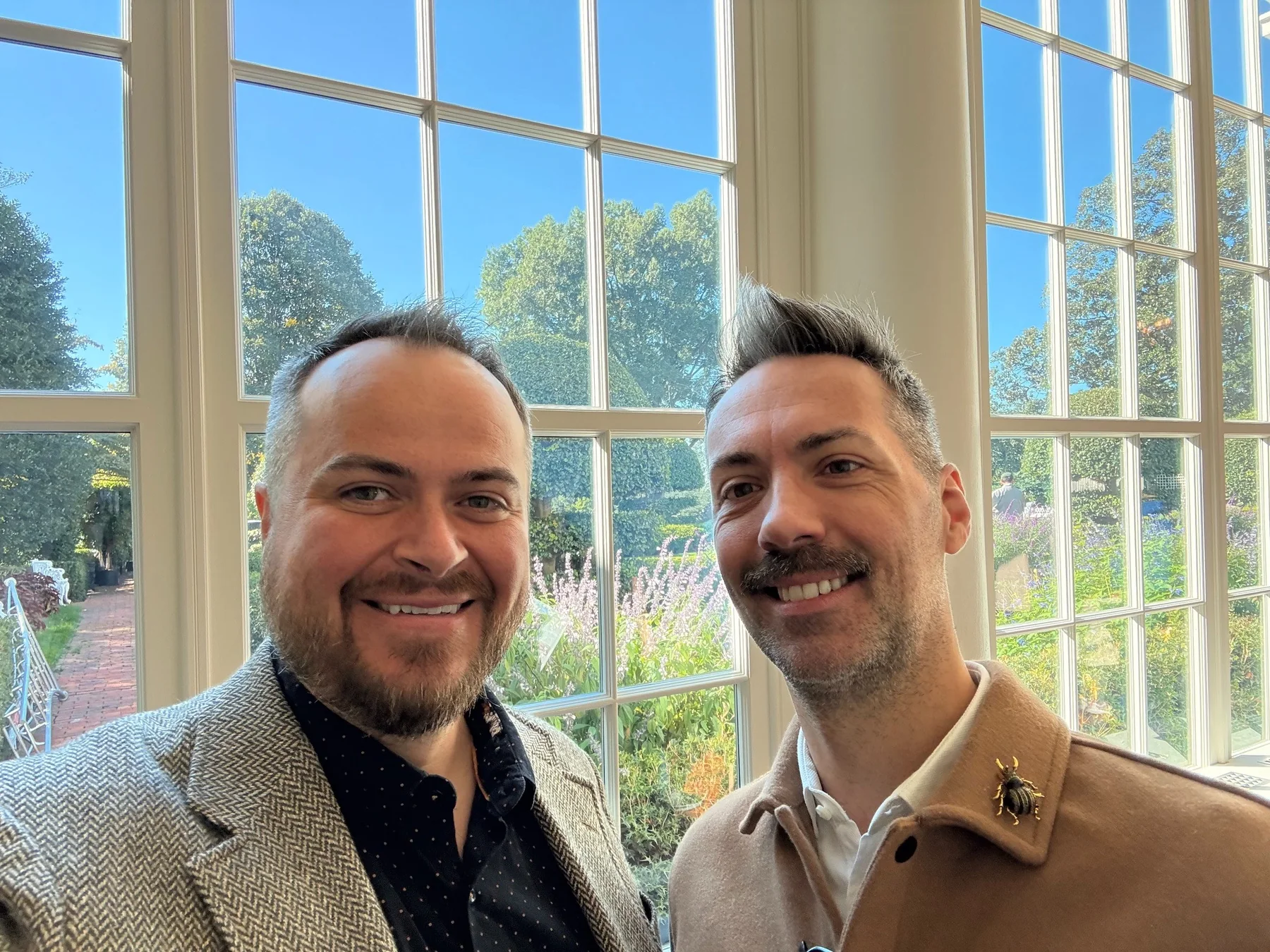 Devon and Jérôme together in a sunlit garden