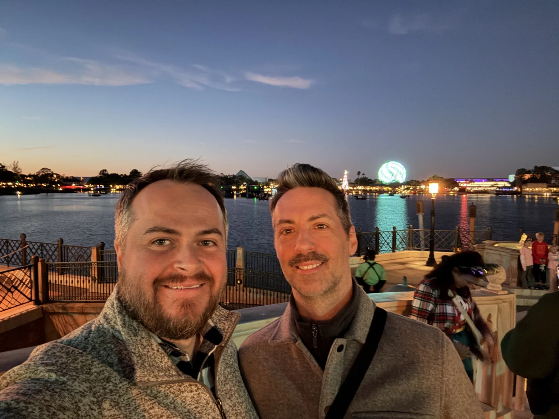Devon and Jérôme together beside the water in the evening